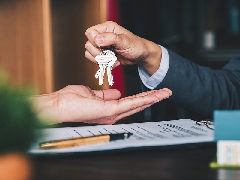 real estate agent giving keys on customer