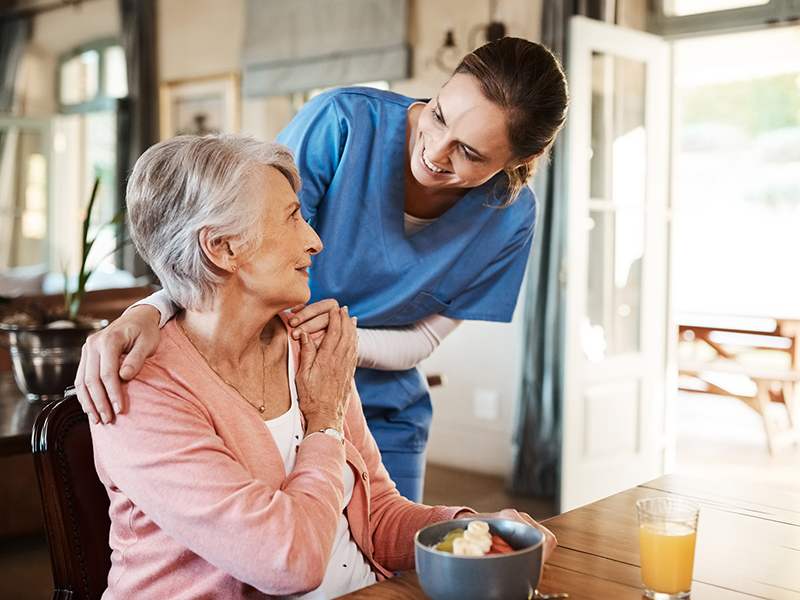 woman giving food by caregiver